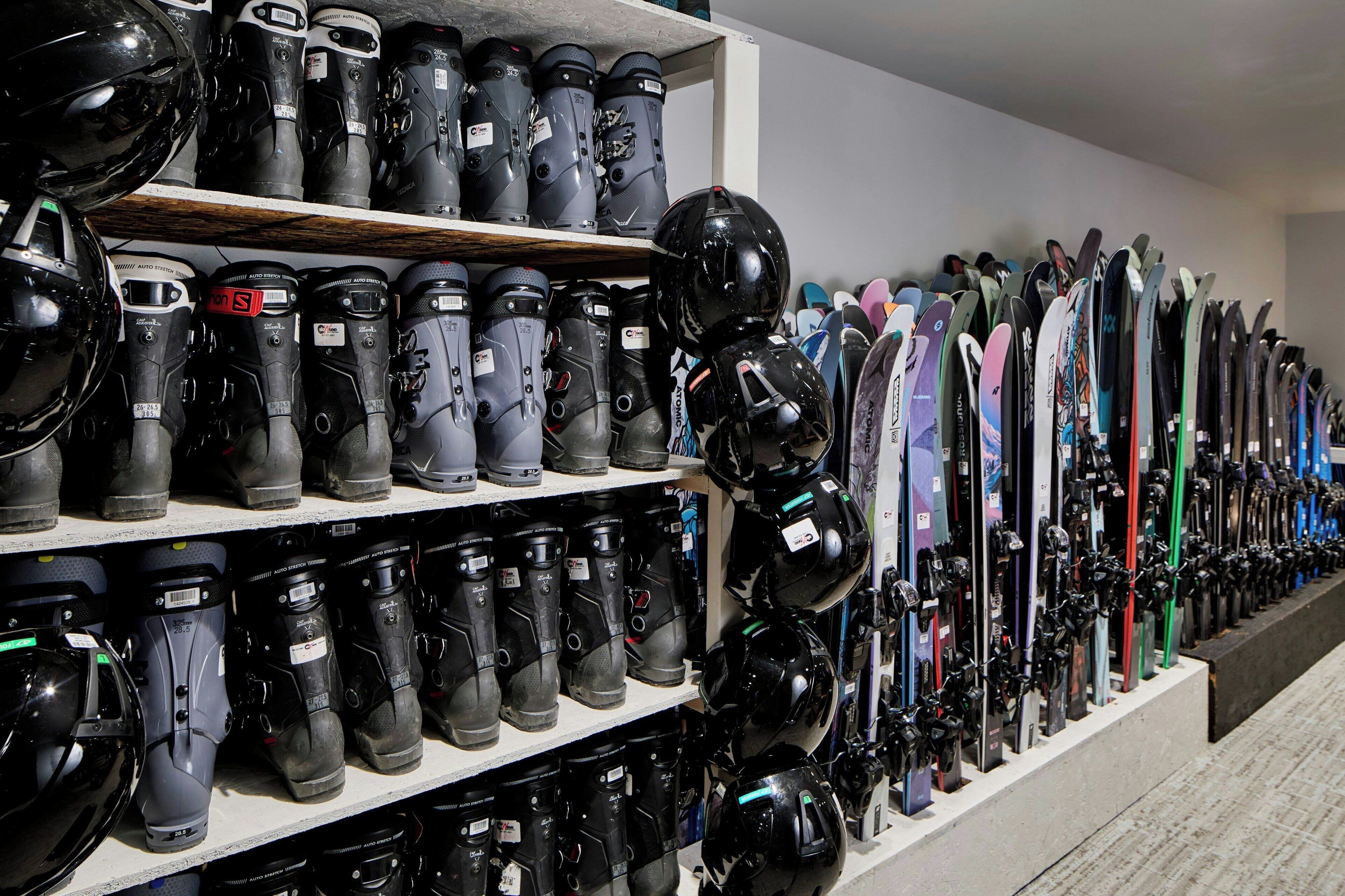 A store with shelves of helmets and skis.