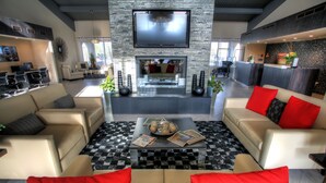 A modern living room with a fireplace, sofas, and a coffee table. - DoubleTree Suites by Hilton Tucson Airport (Tucson)