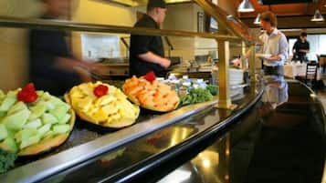 A buffet area with various food items displayed on a counter.