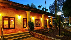 A building with a stone facade, large windows, and a set of steps leading to a door. - DoubleTree Suites by Hilton Tucson Airport (Tucson)