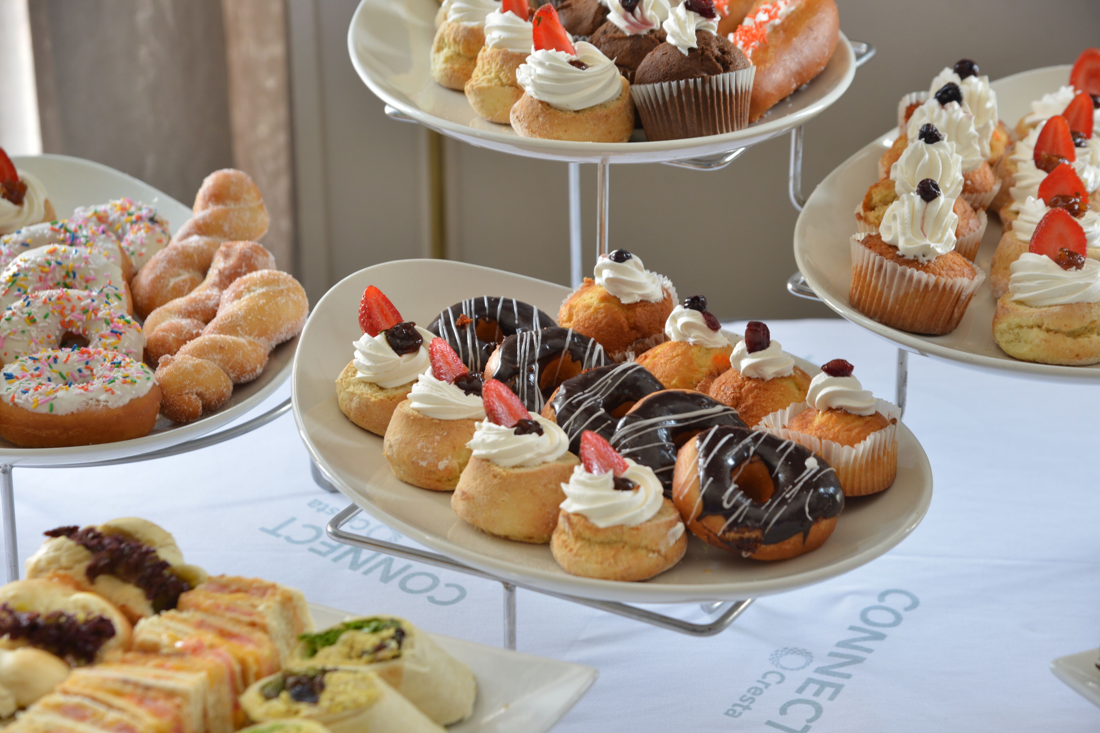 A multi-tiered dessert display with various pastries and tarts.