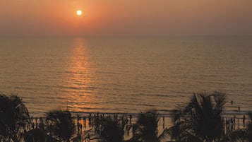 Enjoy breathtaking views of the serene sea and palm trees.