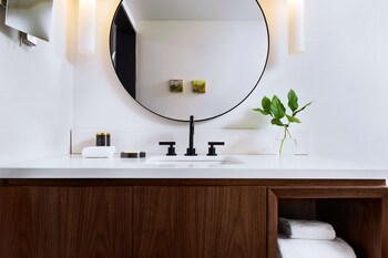 Combined shower/tub, designer toiletries, hair dryer, bathrobes at The Alexis Royal Sonesta Hotel Seattle