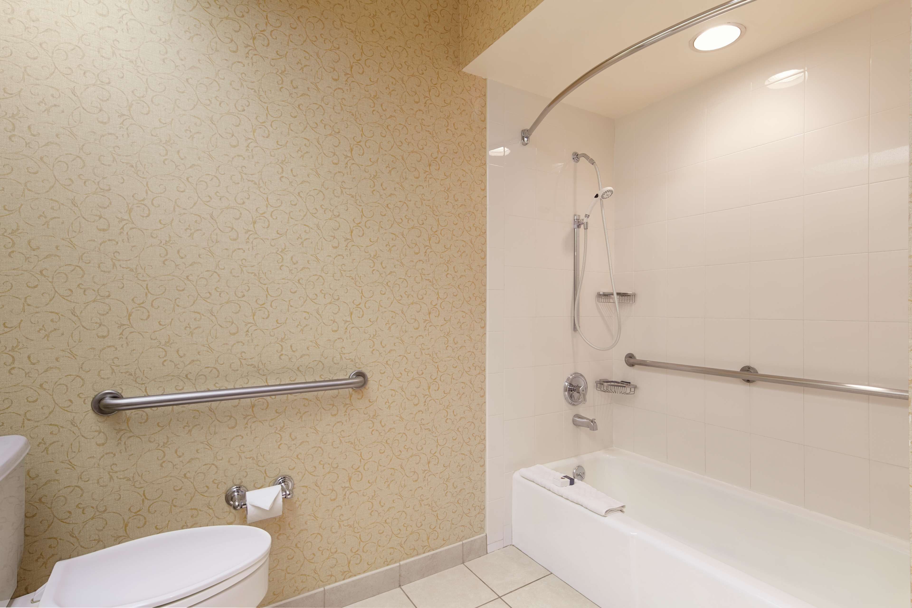 A bathroom with a toilet, a bathtub, and a shower.