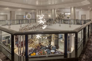 Guests can relax in the inviting lobby, featuring a seating area with sofas and a coffee table.