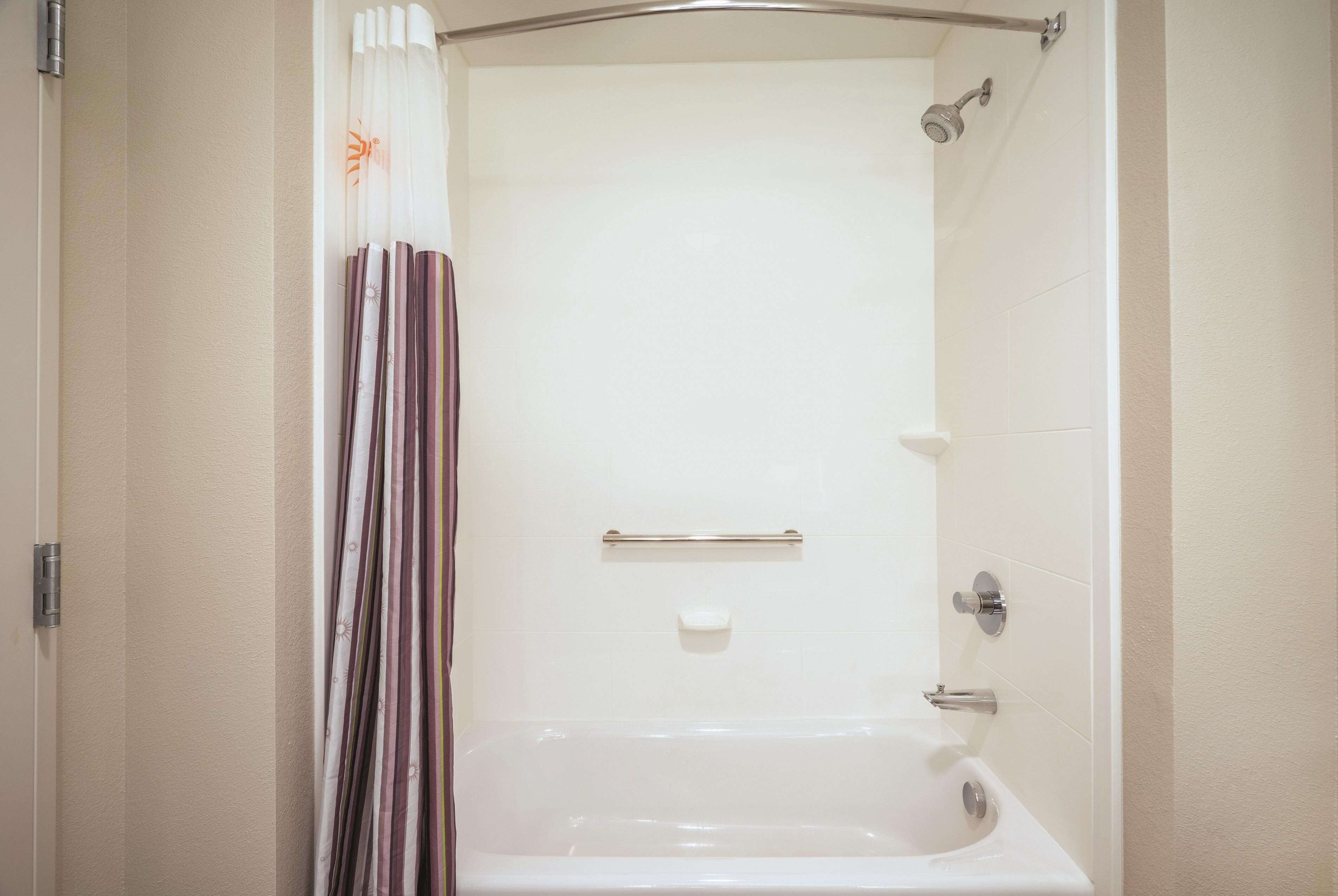 A bathroom with a bathtub, a shower, and a toilet.