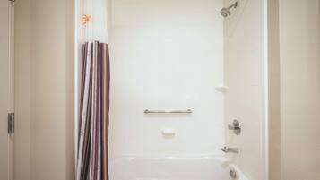 A bathroom with a bathtub, a shower, and a toilet.