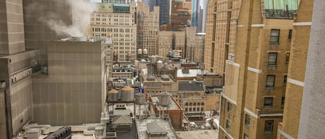 A high-rise urban area with multiple buildings, including a prominent glass skyscraper and several brick structures.