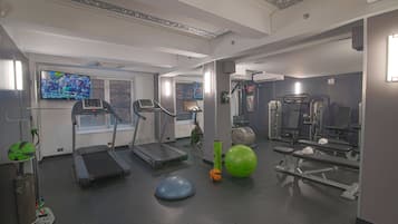 A gym with treadmills, exercise balls, and weight machines.