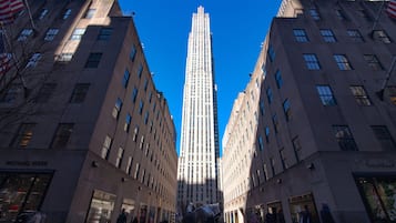 A tall building with a clear blue sky in the background.