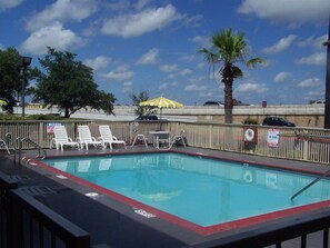 Outdoor pool, open 10 AM to 10:00 PM, pool umbrellas, pool loungers