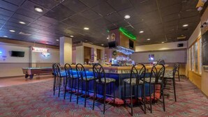 A bar area with a pool table, multiple bar stools, and a neon sign. -  Inn at Lebanon - Hershey & Manheim area (Lebanon)