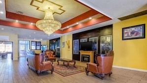 A spacious lobby with a chandelier, leather armchairs, a fireplace, and a television. -  Inn at Lebanon - Hershey & Manheim area (Lebanon)