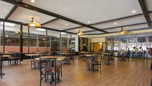 A spacious dining area with wooden flooring, tables, and chairs arranged for dining. -  Inn at Lebanon - Hershey & Manheim area (Lebanon)