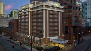 A multi-story hotel with a prominent "HOME 2" sign, featuring a modern architectural design with a mix of glass and brick facades. - Home2 Suites by Hilton Atlanta Midtown (Atlanta)