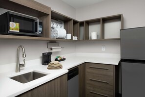 Fridge, microwave, coffee/tea maker, cookware/dishes/utensils