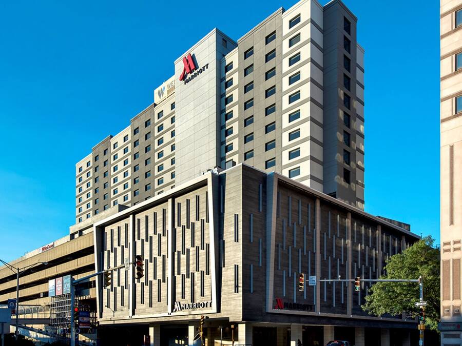 A multi-story hotel with a modern design, featuring a prominent Marriott logo.