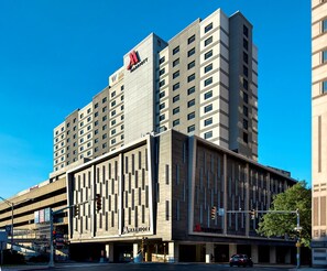 A multi-story hotel with a modern design, featuring a prominent Marriott logo.