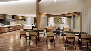 A spacious dining area with a large marble table and multiple chairs, a kitchen with wooden cabinets, and a modern ceiling light fixture. - Marriott Springfield Downtown (Springfield)