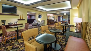 A hotel lobby with seating areas, a flat-screen TV, and a patterned carpet. - Hampton Inn Baton Rouge - I-10 & College Dr. (Baton Rouge)