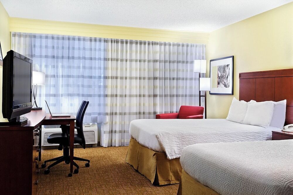 Hypo-allergenic bedding, desk, laptop workspace, blackout drapes