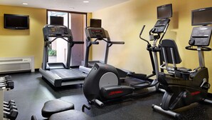 A gym with treadmills, elliptical machines, and dumbbells. - Heritage Place Houston Brookhollow (Houston)