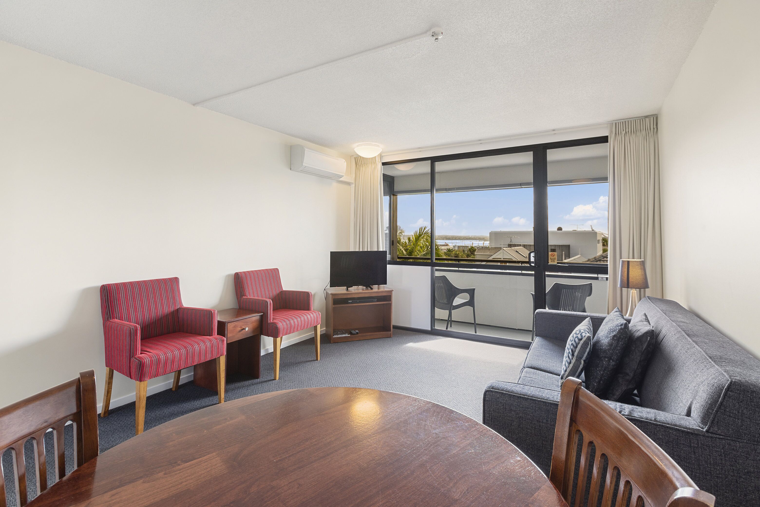 one bedroom suite with balcony | living area | 42-inch smart tv with satellite channels