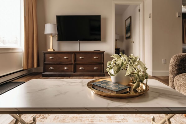 Superior Suite, 2 Queen Beds | Living area | 32-inch flat-screen TV with cable channels, TV