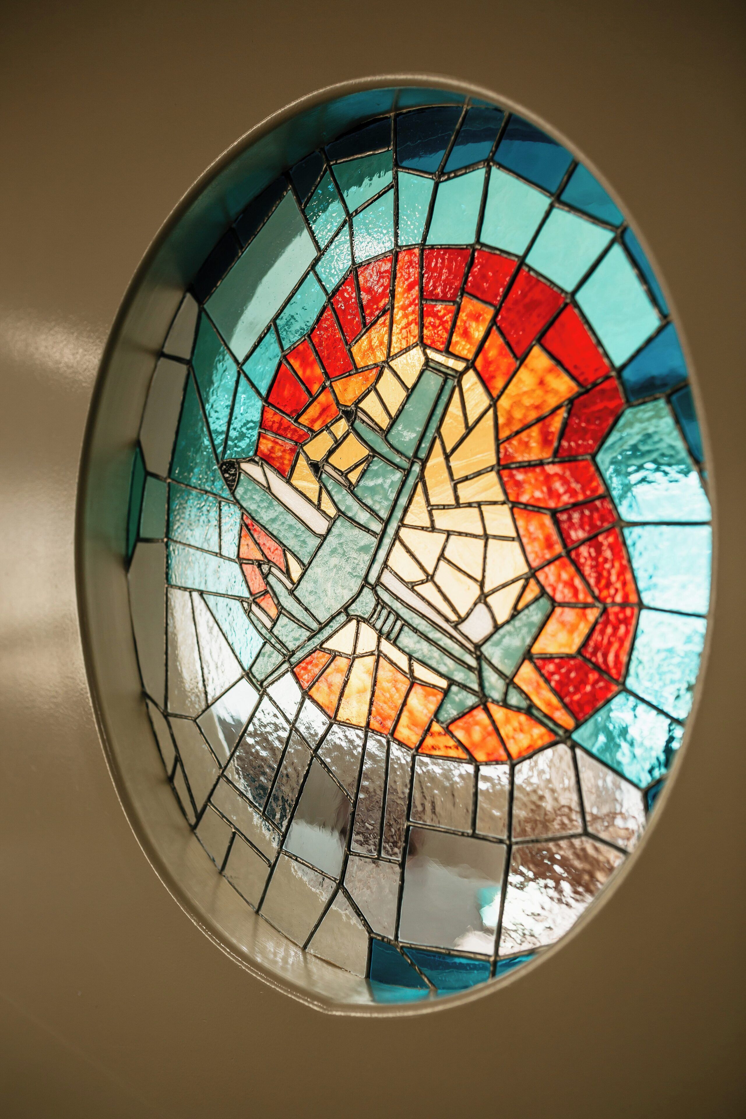 A circular stained glass window with a geometric design.