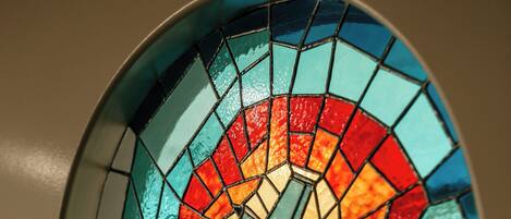 A circular stained glass window with a geometric design.