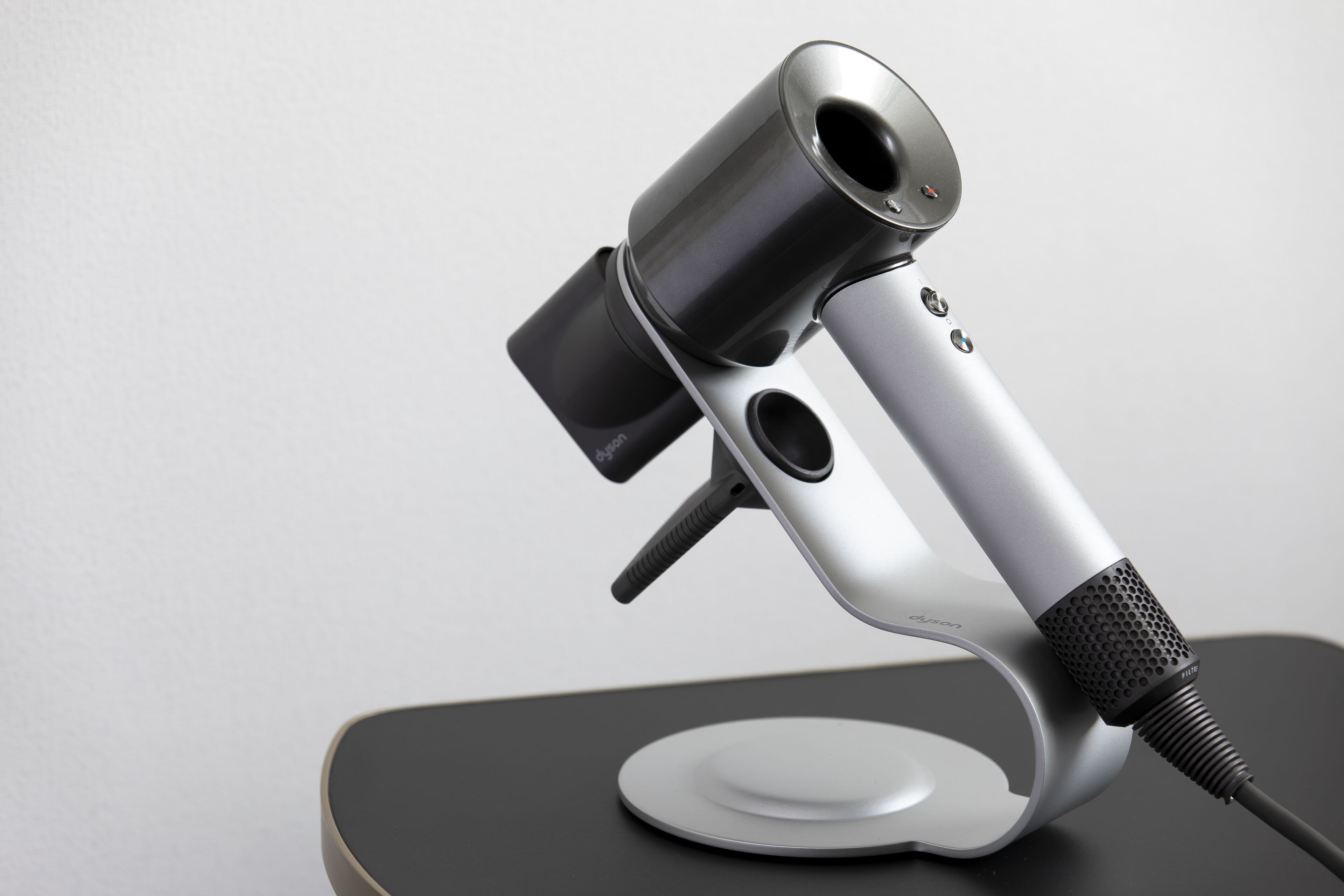A modern, metallic desk lamp with a flexible neck and a base.