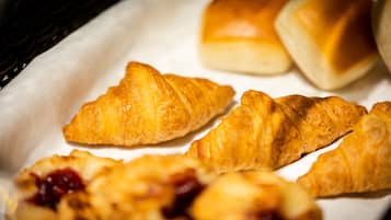 Una bandeja con pasteles, incluyendo croissants y bollos.