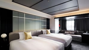 A modern hotel room with two large beds, a seating area, a large window, and a modern ceiling design. - Cross Hotel Osaka(ORIX HOTELS & RESORTS) (Osaka)