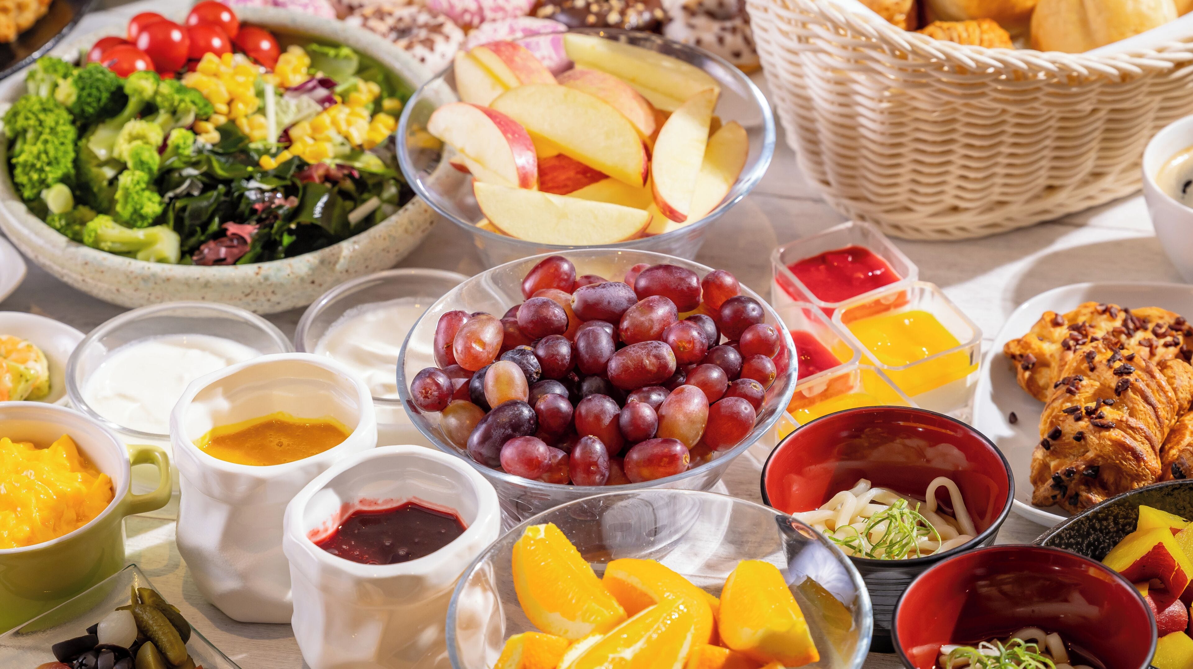 A variety of food items including fruits, vegetables, and bread on a table.