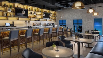 A modern bar area with seating and a counter.