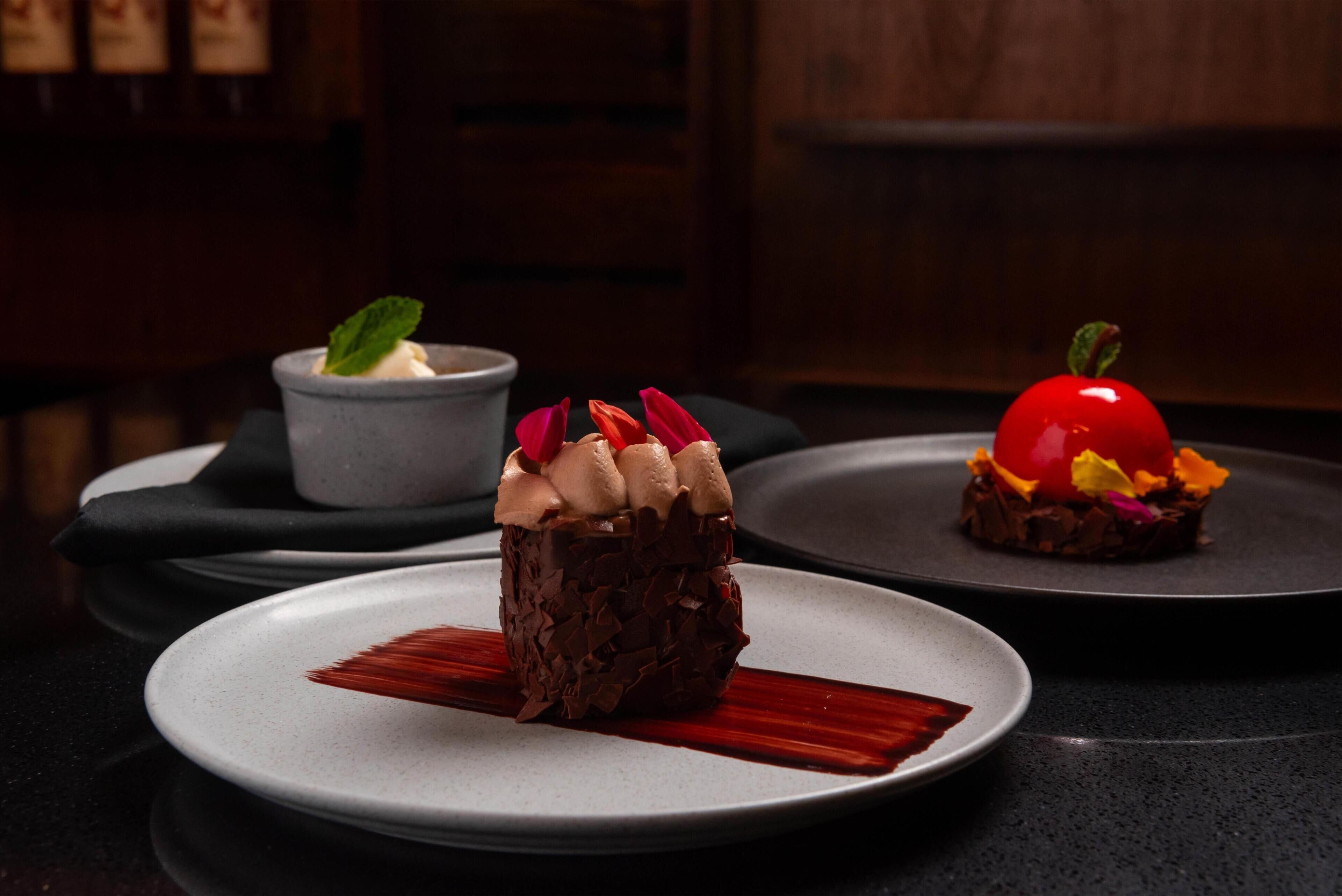 A dessert presentation on plates with a dark background.