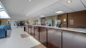 A reception area with a counter, seating, and a clock on the wall.
