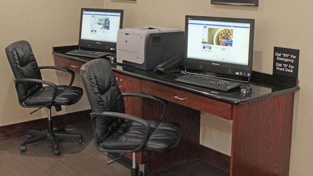 A workspace with two computers, a printer, and two black leather chairs. - Hampton Inn Norfolk/Chesapeake (Greenbrier Area) (Chesapeake)