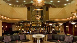 A spacious lobby with leather sofas, a central fountain, and a bar area. - Sofitel Algiers Hamma Garden (Algiers)