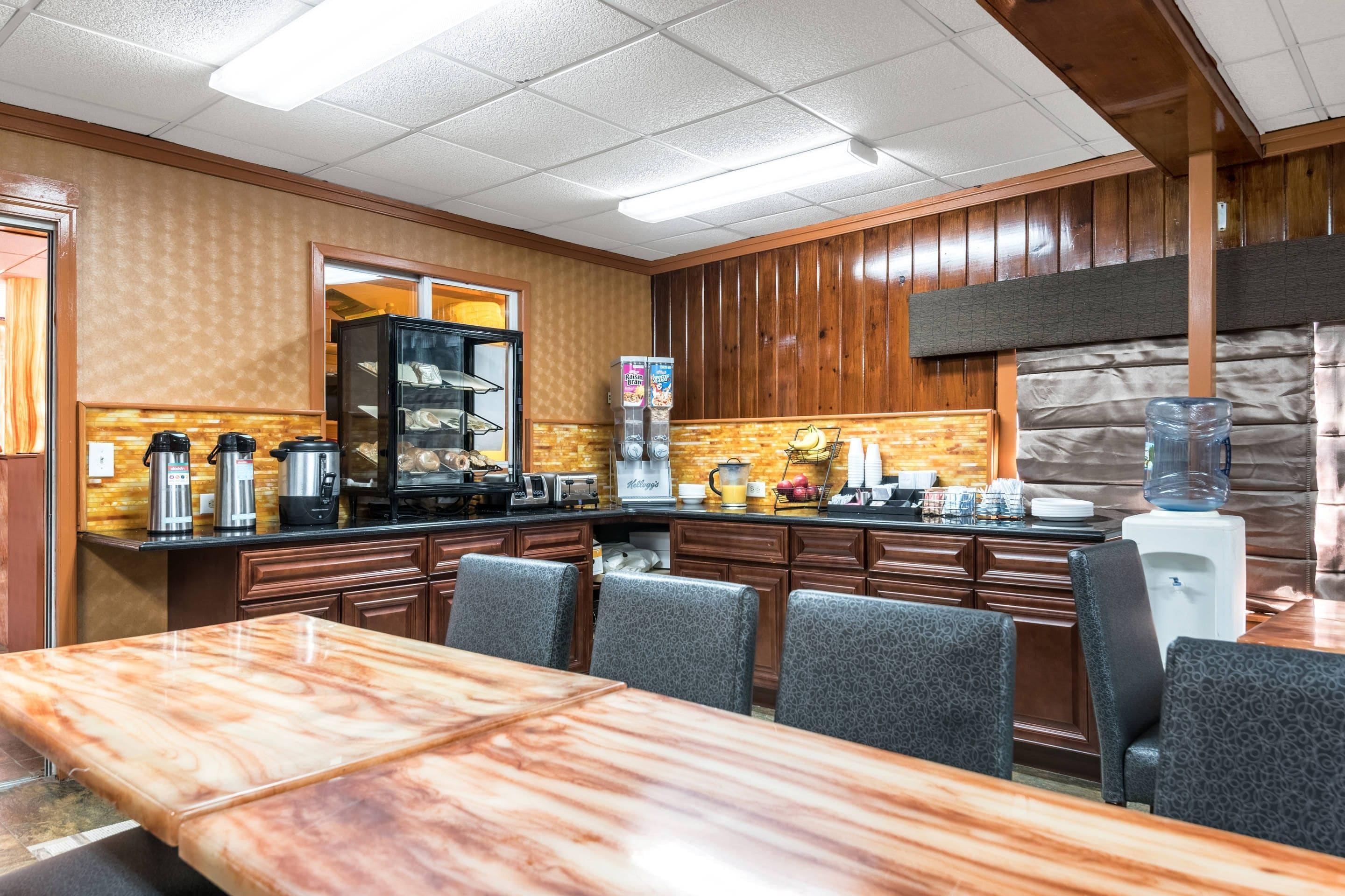 A restaurant with a marble counter, wooden paneling, and a buffet setup.