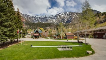 A town square with a green lawn, benches, and a building labeled "The Spectacular Saloon."
