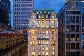 A historic building with ornate architectural details, multiple floors, and illuminated windows. - The St. Regis New York (New York)