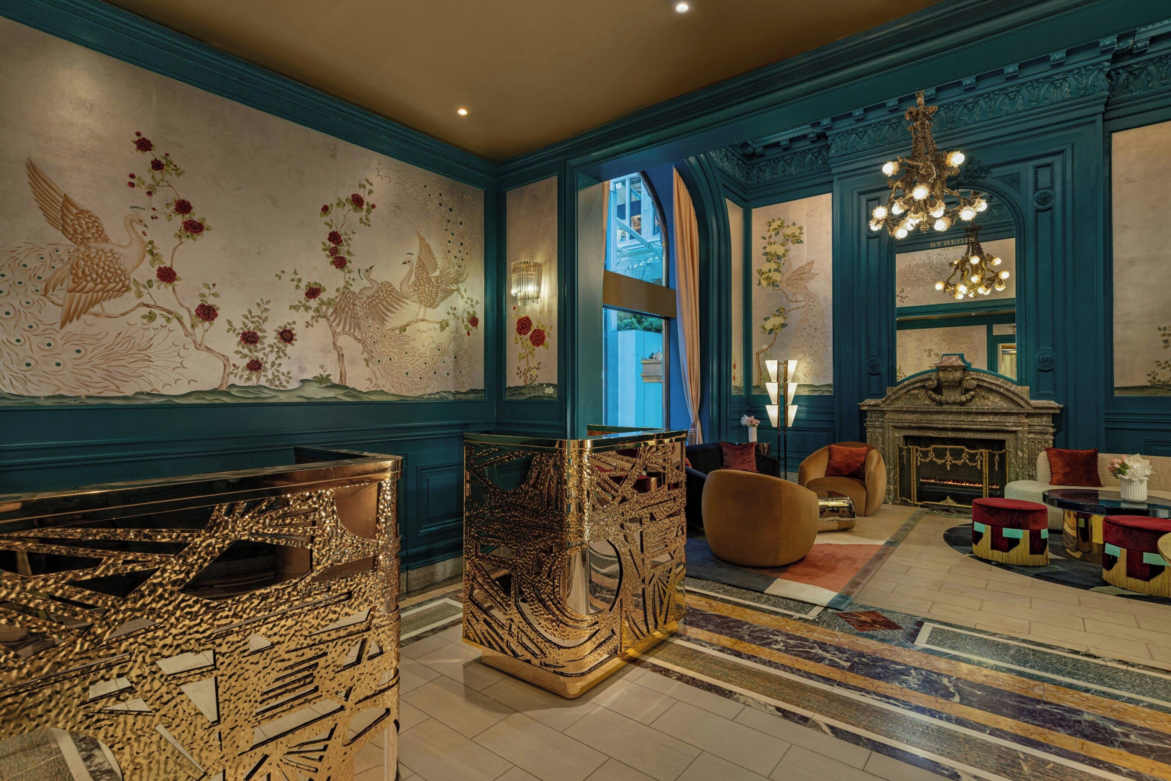 A luxurious interior with ornate wall art, a grand chandelier, and a fireplace.
