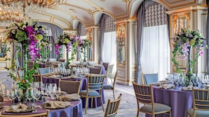 A luxurious dining room with ornate chandeliers, elegant table settings, and classic wooden chairs. - The St. Regis New York (New York)
