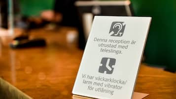 A sign with instructions for reception and a safe deposit box.