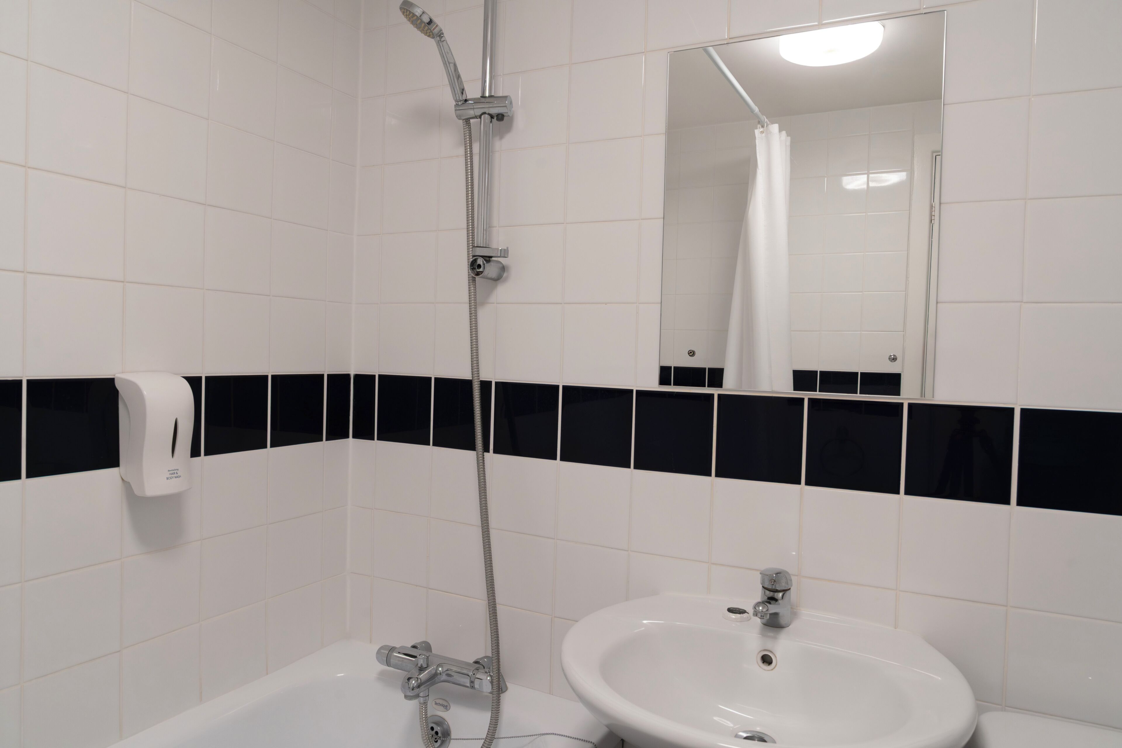 A bathroom with a bathtub, a sink, and a shower.