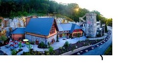 A resort with a stone building, a blue-roofed structure, and a stone tower. - Knights Inn Chattanooga (Chattanooga)