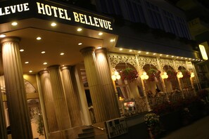 Hotel Bellevue features a grand entrance with ornate balcony and columns.