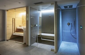 A modern bathroom with a glass-enclosed shower, a visible toilet, and a sink area. - Hilton London Croydon (Croydon)