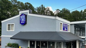 A building with a sign reading "NAITION'S INN" and a covered entrance area.
